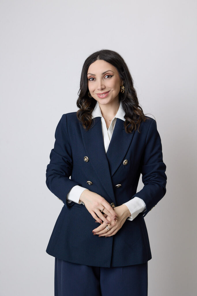 Elizabeth Keshishyan in a navy suit and white shirt