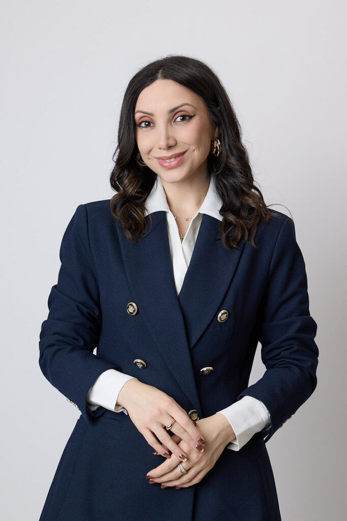 Elizabeth Keshishyan in a navy suit and white shirt